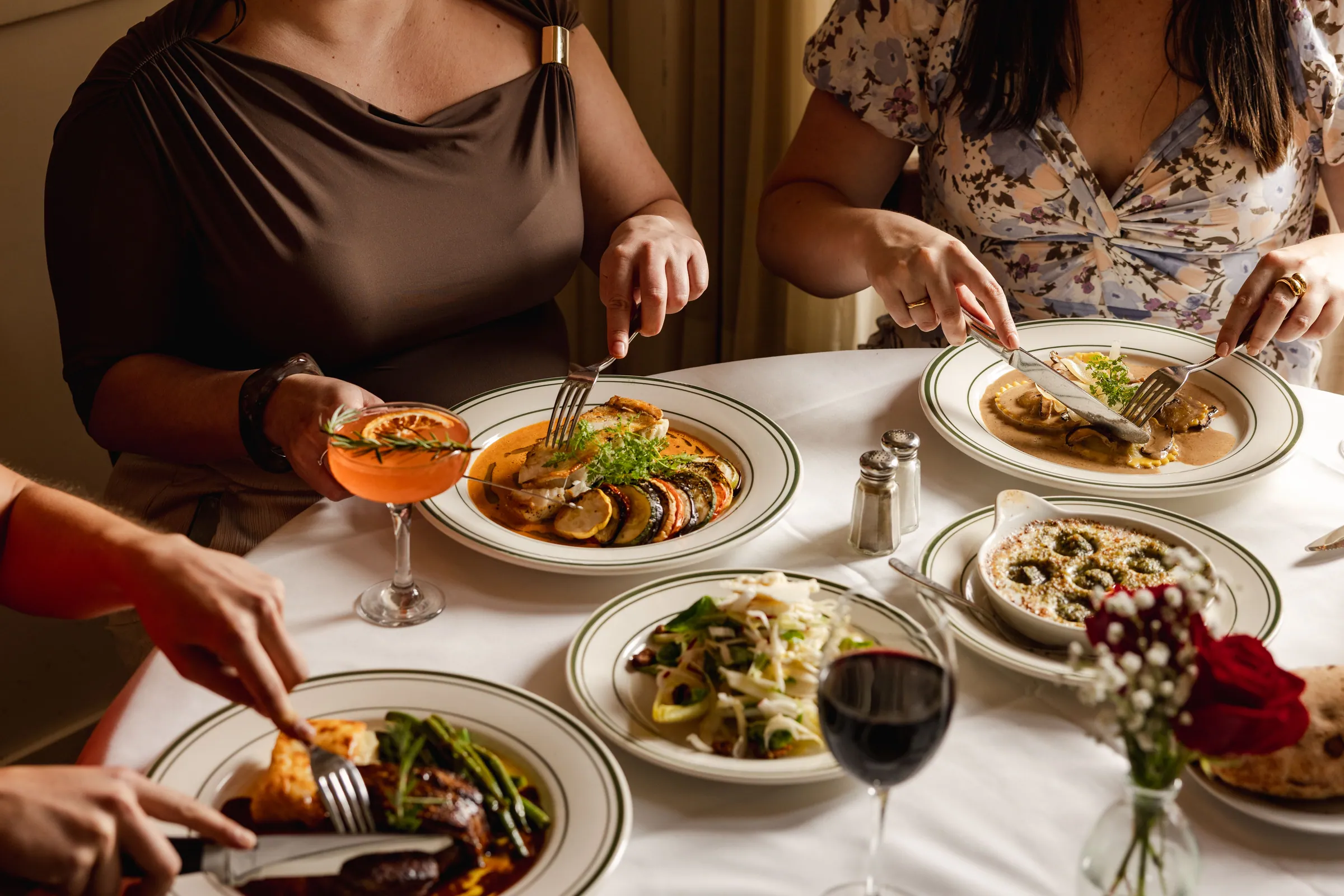 Guests sharing plates at a Le Monde dinner